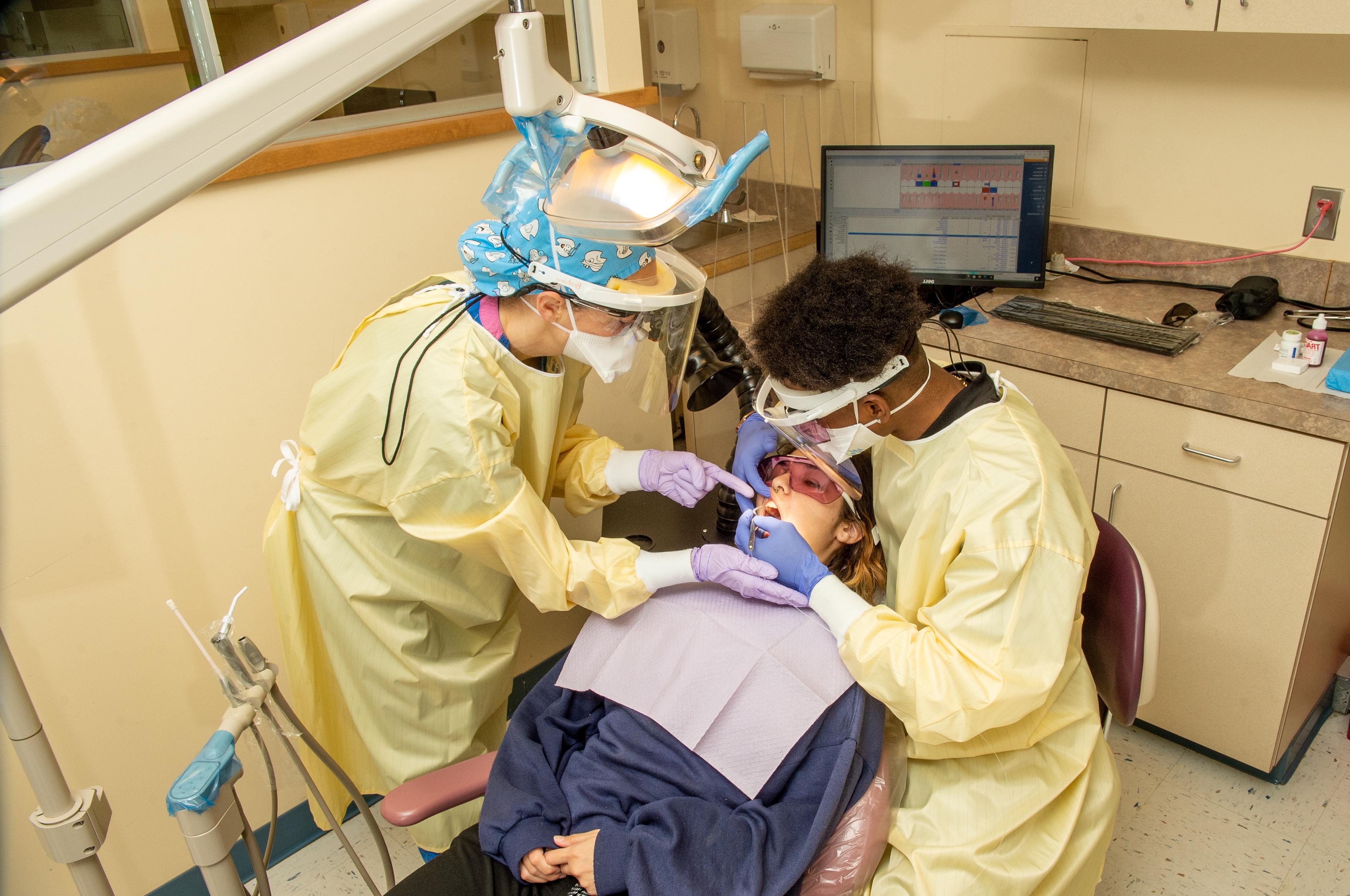 Dental hygiene student treats patient